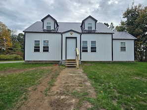 A two-story building with a central entrance and a small porch.