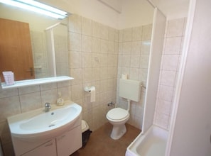 A bathroom with a sink, toilet, and bathtub. - Apartments Gogi (Okrug)