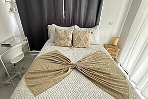 A hotel room with a bed, a desk, a chair, and a nightstand. - Lux 2-Story 3BR Villa + Private Pool (Punta Cana)
