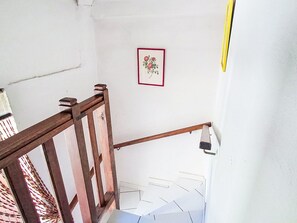 A staircase with wooden railings and a white wall with a framed picture. - Villa le Cédre 17 by Interhome (Six Fours)