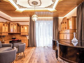 A room with wooden flooring, a bar area with a polished surface, and a chandelier. - Villa 10 by Interhome (Ötz)