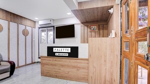 A reception desk with a sign reading 'PALETTE' and 'OYO-Serviced'. - Palette Virar Mumbai (Vasai)