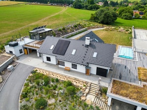 A modern house with a sloped roof, solar panels, and a garden with steps leading to the entrance. - V Šachu by Interhome (Dačice)
