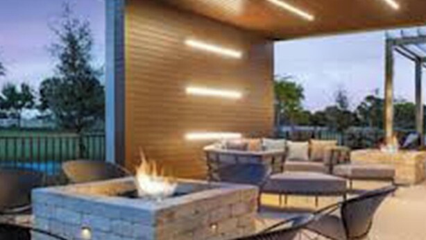 Un espace extérieur aménagé avec une terrasse, un foyer et une vue sur le paysage environnant.
