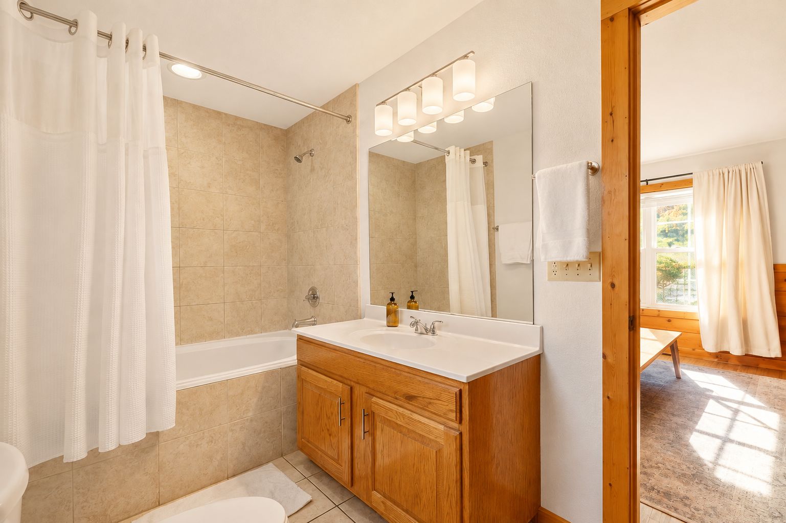 Shower or bathe in the tub combo, then style your hair at the big mirror.