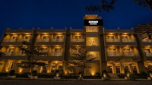 A multi-story hotel with a central entrance, balconies on each floor, and a sign indicating the name 'PALETTE'. - Palette Virar Mumbai (Vasai)