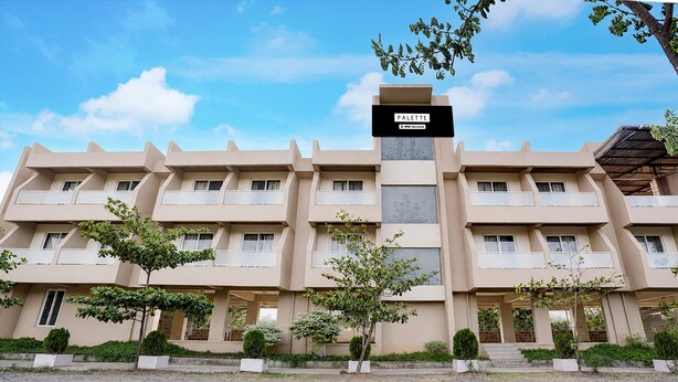 A multi-story hotel with a flat facade, balconies, and a sign indicating 'PALETTE' and 'OYO-Serviced'. - Palette Virar Mumbai (Vasai)