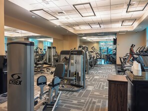 A gym with exercise equipment, treadmills, and a mirrored wall. - Designer Remodeled Strip View Suite With Balcony at the MGM Signature Las Vegas (Las Vegas)