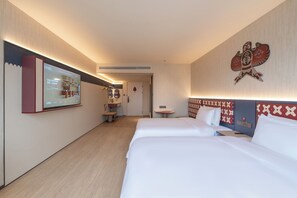 A hotel room with two beds, a small table, a wall-mounted TV, and a bathroom visible through an open door. - Ni Hao Hotel Guangzhou Panyu Shiqiao (Guangzhou)