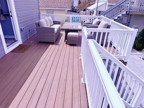A wooden deck with outdoor furniture, a white railing, and a clear sky. - New! Oceanside Oasis - 2nd Home from Beach (Seaside Park)
