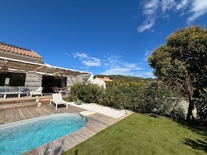 A backyard with a swimming pool, a wooden deck, and a grassy lawn. - Magnificent Villa With Swimming Pool in Marseille (Marseille)