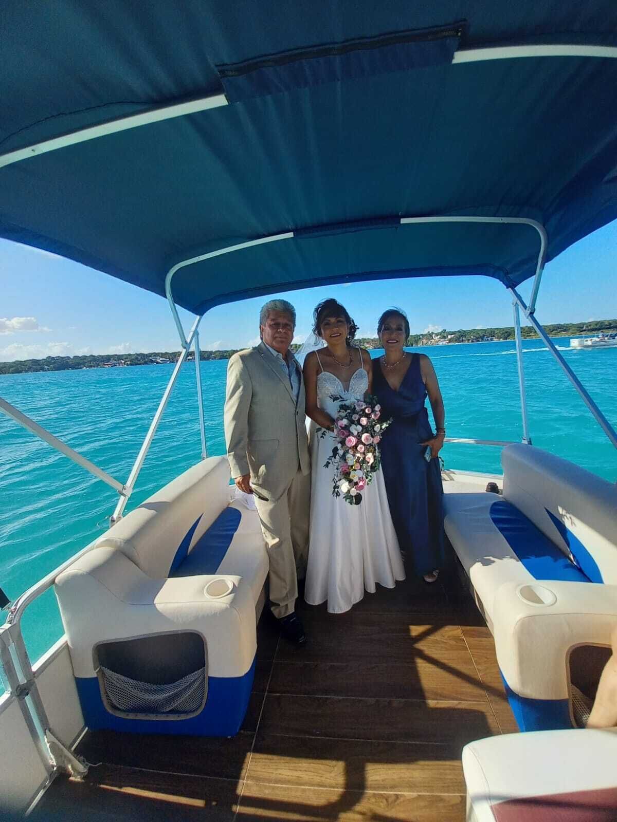 A boat with a covered deck, seating areas, and a view of the sea.