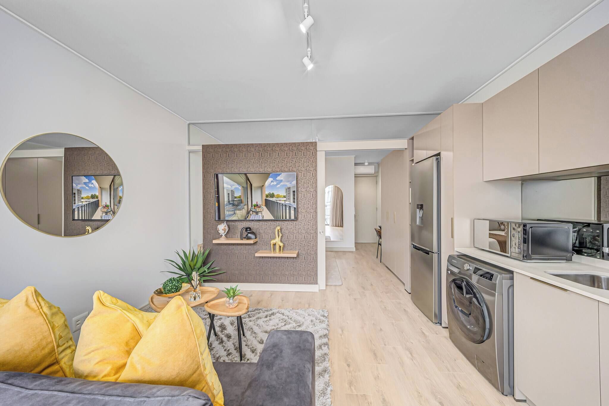 A modern apartment with a living room, kitchen, and dining area.