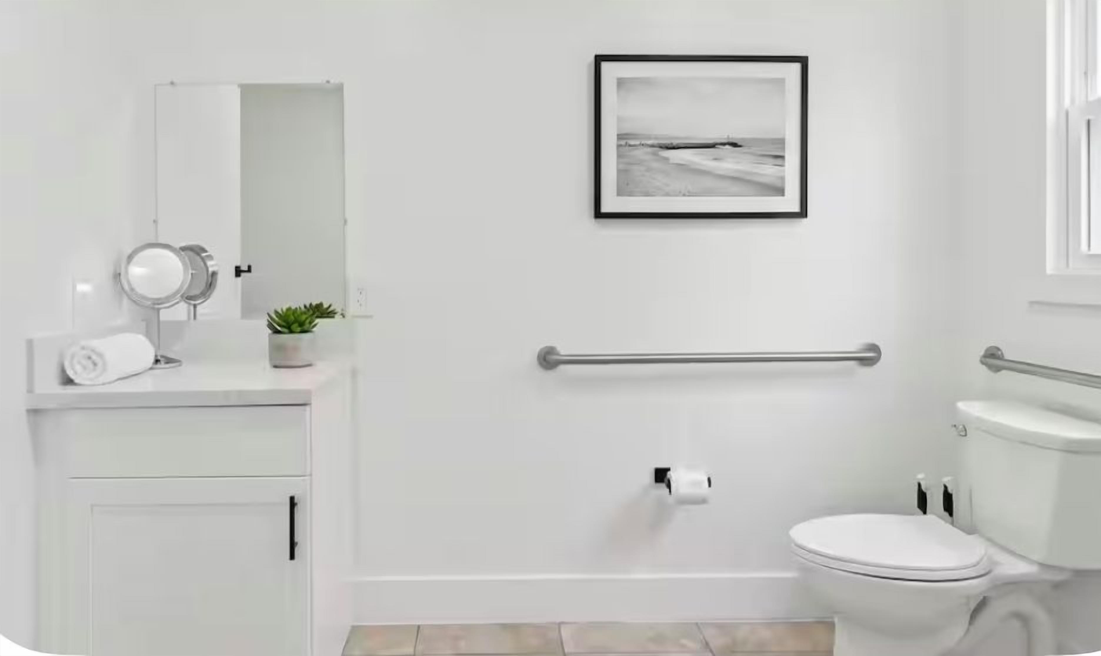 A modern bathroom with a toilet, bidet, and a small sink area.