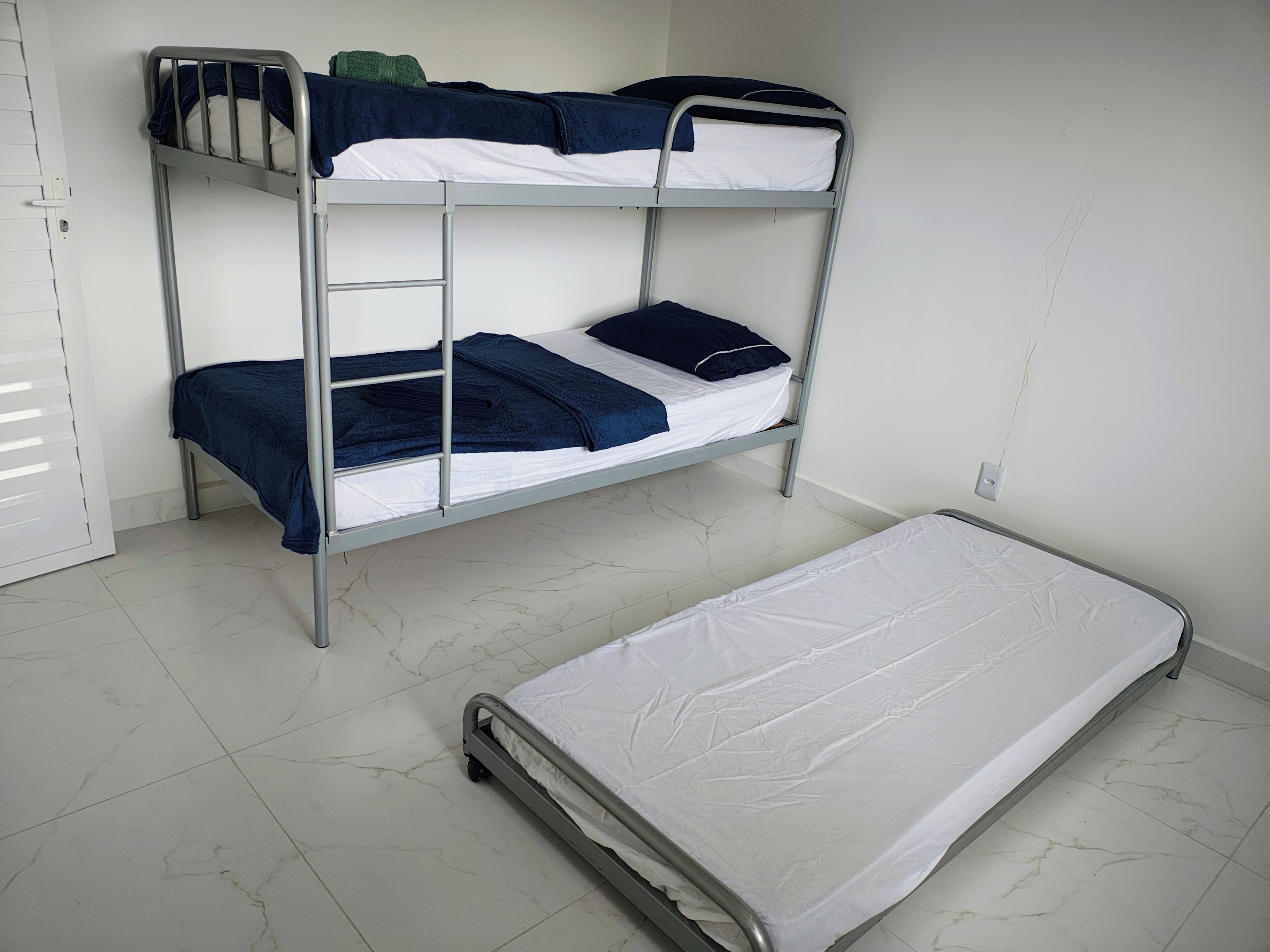 A bunk bed with a mattress on the floor.