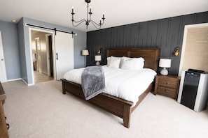 A bedroom with a bed, bedside tables, a chandelier, and a built-in appliance. - Sound View Retreat Near Illahee Beach & Ferry (Bremerton)