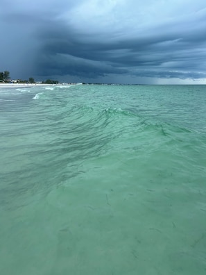 A beach with clear turquoise water and a cloudy sky. - PRISTINE CONDO, 1st floor, 2 bed/2 bath, Golfers PARADISE at Calusa Country Club (Lakewood Ranch)
