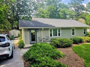 A single-story house with a front door, two windows, and a garage door. - Perfect 2-bedroom house with AC in quaint Decatur (Decatur)