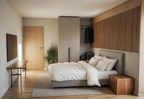 A bedroom with a bed, bedside table, and a wardrobe.