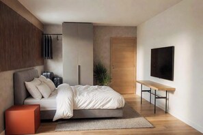 Un dormitorio moderno con cama, banca, armario, televisor y planta.