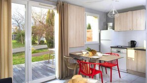 Una cocina moderna con comedor, ventanas amplias y vistas al exterior.