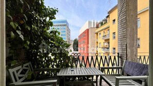 A balcony with a table and chairs, surrounded by a metal fence and greenery. - Penthouse 200 sqm 5 min walk from Duomo Milano cathedral. Vip Are sleeps 10 max (Milano)