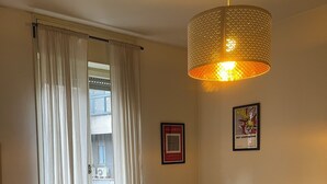 A bedroom with a bed, a chair, a desk, a lamp, and a window with curtains. - Penthouse 200 sqm 5 min walk from Duomo Milano cathedral. Vip Are sleeps 10 max (Milano)