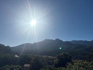 A mountain landscape with a clear sky and the sun shining brightly. - New: Enjoy a peaceful vacation in Corsica (Tavaco)
