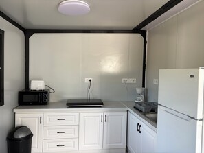 A compact kitchen with a microwave, toaster, coffee maker, and a refrigerator. - New: Enjoy a peaceful vacation in Corsica (Tavaco)