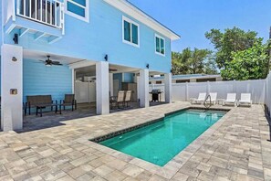 A blue house with a swimming pool, outdoor seating, and a covered patio area. - Beach Time  - Elevator - Pool - 3 Min to Beach (Fort Myers Beach)