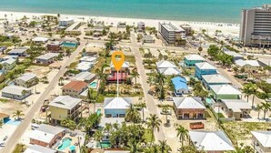 An aerial view of a coastal resort with multiple buildings, a beach, and a clear view of the ocean. - Beach Time  - Elevator - Pool - 3 Min to Beach (Fort Myers Beach)