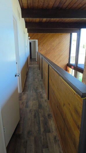 A corridor with wooden walls and a wooden ceiling, leading to a door at the end. - Spacious 6-bedroom 4 toilets house in Houston Texas  available for short rent (Houston)