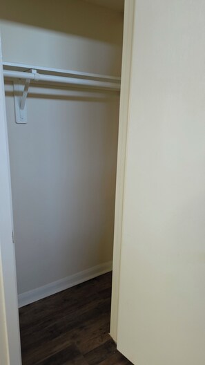 A closet with a white door, a wooden floor, and a white ceiling. - Spacious 6-bedroom 4 toilets house in Houston Texas  available for short rent (Houston)