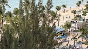 A beach resort with a pool, palm trees, and a pier. - My Paradise: Tropical, 3-star, beach, sand—everything at your fingertips (Carolina Puerto Rico)