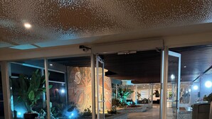 A lobby with a glass entrance, a tiled floor, and a decorative ceiling. - My Paradise: Tropical, 3-star, beach, sand—everything at your fingertips (Carolina Puerto Rico)