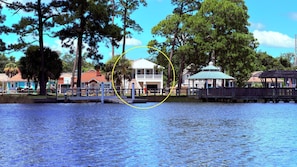 A waterfront property with a dock, a gazebo, and a building with a green roof. - Bayou Breeze  - Pool + Waterfront Views + 8 Minutes to Downtown Pensacola (Pensacola)