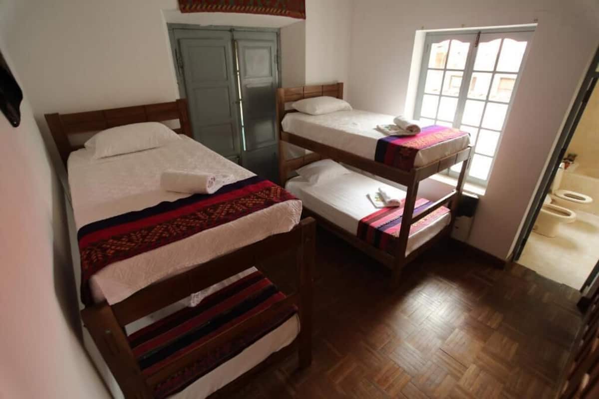 Una habitación con literas, un armario y ventana con vistas.