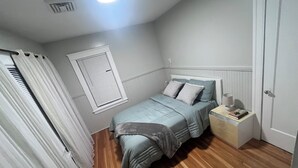 A bedroom with a bed, a nightstand, a window with blinds, and a door. - Clean & Cozy Private room - 3 floor_R 1 (Worcester)
