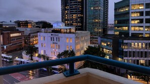 A cityscape at dusk with modern buildings, a bus, and a clear sky. - Queen Street CBD Stay with Balcony and Amenities (Brisbane City)