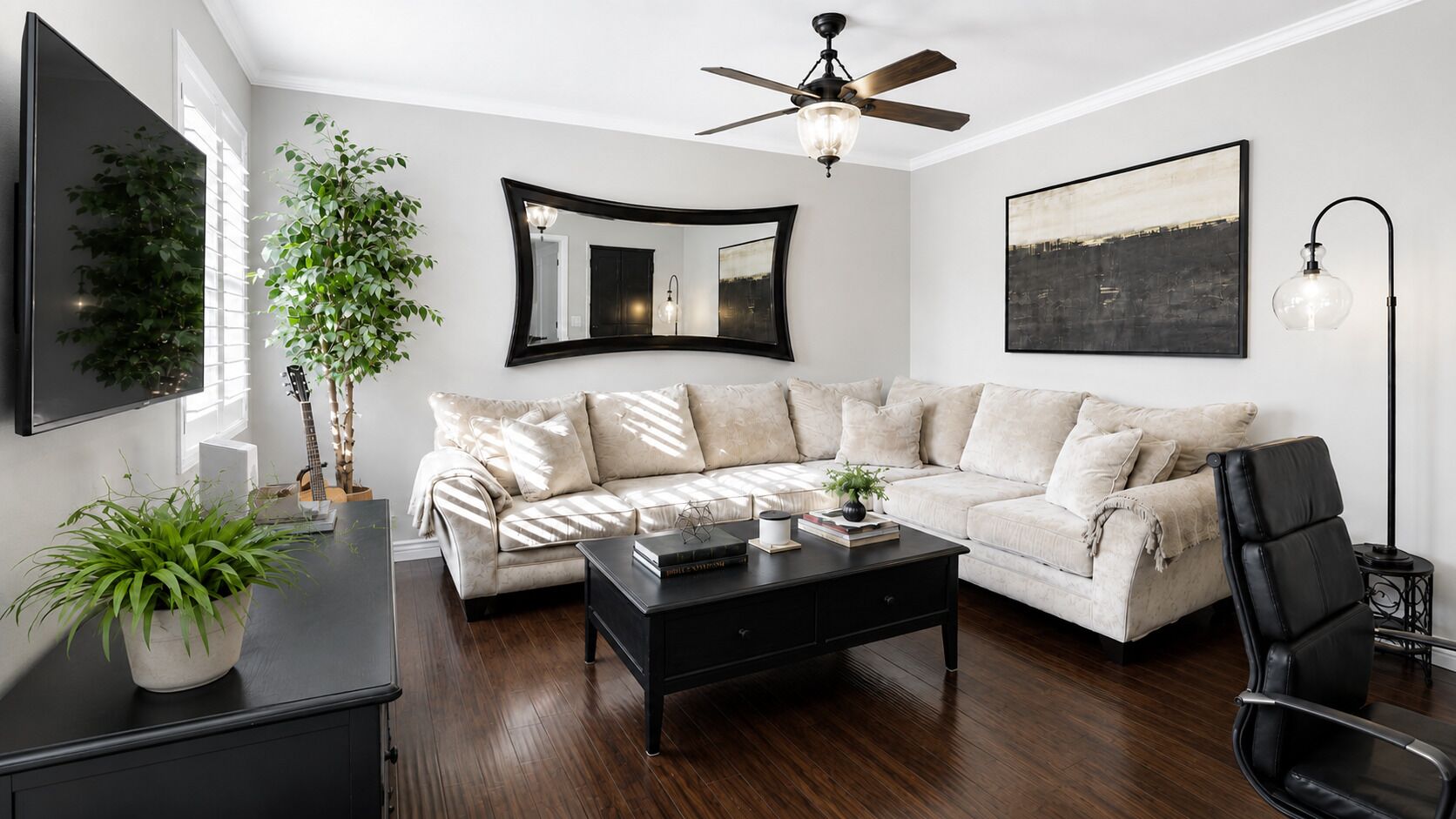 A living room with a sofa, coffee table, and a ceiling fan.