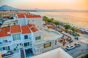 A coastal hotel with a terrace, a signboard, and a view of the sea. - Beach Blue Villa , Luxury 3-Bedroom Villa with Sea View (Korinthos)