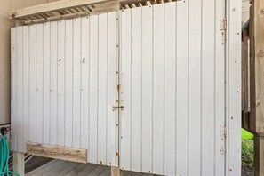 A white metal door with a wooden frame, a metal latch, and a small metal plate. - White Dune: Dogs Allowed, Basketball Goal, Easy Beach Access (Avon)