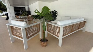 A white outdoor seating area with wicker partitions and a central potted plant. - New - Sleeps 10 Private Pool and Fenced Yard (Orlando)