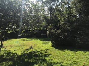 A grassy outdoor area with trees and a structure in the background. - 4 Star Holiday Home in Frederiksvaerk (Frederiksvaerk)