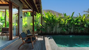 A pool area with wooden deck, lounge chairs, and tropical plants. - Apura Panoramic Villa 2BD Ubud (Ubud)