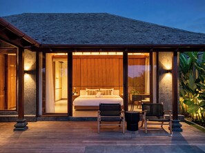 A bedroom with a large bed, two chairs, and a table. - Apura Panoramic Villa 2BD Ubud (Ubud)