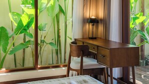 A room with a desk, chair, and a large window with plants. - Apura Panoramic Villa 2BD Ubud (Ubud)