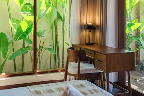 A room with a desk, chair, and a large window with plants. - Apura Panoramic Villa 2BD Ubud (Ubud)