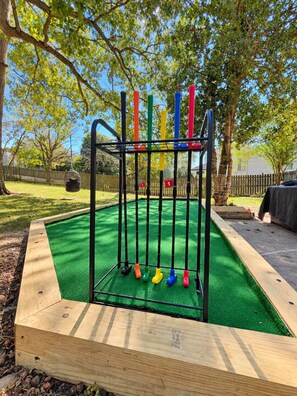A playground with a climbing structure and a green artificial turf surface. - 1917 Bristol Tudor, Sleeps 10, Minutes to Downtown, BMS Speedway & Holston River (Bristol)