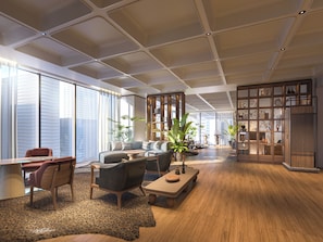 A spacious living area with a large window, a seating arrangement, and a bookshelf. - Mitsui Garden Hotel Osaka Dojimahama PREMIER (Osaka)